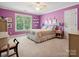 Charming bedroom with a double bed and purple walls at 418 Sebring Ct, Belmont, NC 28012
