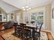 Bright dining room featuring a spacious table and chairs, hardwood floors, and access to a patio at 418 Sebring Ct, Belmont, NC 28012