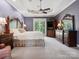 Main bedroom with king-size bed, ceiling fan, large window with wooded views and hardwood floors at 418 Sebring Ct, Belmont, NC 28012