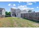 Large backyard with gray house and wooden fence at 14949 Holbrooks Rd, Huntersville, NC 28078