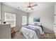 Well-lit bedroom with ceiling fan and window coverings at 14949 Holbrooks Rd, Huntersville, NC 28078