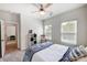 Bedroom with ceiling fan, window coverings and access to another room at 14949 Holbrooks Rd, Huntersville, NC 28078