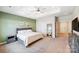 Spacious bedroom with carpeted floor, ceiling fan, and built-in workspace at 14949 Holbrooks Rd, Huntersville, NC 28078