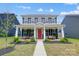 Two story home with red front door and front porch at 14949 Holbrooks Rd, Huntersville, NC 28078