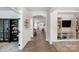 Long hallway with built-in shelving and access to various rooms at 14949 Holbrooks Rd, Huntersville, NC 28078