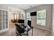 Bright home office with dual monitors and built-in shelving at 14949 Holbrooks Rd, Huntersville, NC 28078