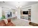 Home office with built-in shelving and a view into the living room at 14949 Holbrooks Rd, Huntersville, NC 28078