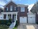 Two-story brick townhome with a well-maintained lawn and a two-car garage at 19307 Beaufain St, Cornelius, NC 28031
