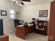 A well-lit office with a ceiling fan, a large desk and ample storage space at 19307 Beaufain St, Cornelius, NC 28031