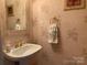 Stylish powder room featuring sink and custom wallpaper at 19307 Beaufain St, Cornelius, NC 28031