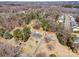 Aerial view of the property and surrounding neighborhood with mature trees at 1206 Mineral Springs Rd, Charlotte, NC 28262