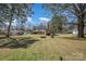 This large property includes an outbuilding, fire pit, and plenty of yard space at 1206 Mineral Springs Rd, Charlotte, NC 28262