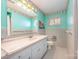 Cozy bathroom with a marble countertop sink, vintage wallpaper and a large mirror at 1206 Mineral Springs Rd, Charlotte, NC 28262