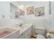 Bathroom with a white sink vanity, framed art and a matching toilet at 1206 Mineral Springs Rd, Charlotte, NC 28262