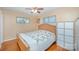 Comfortable bedroom with wood floors, a ceiling fan, and two windows for ample natural light at 1206 Mineral Springs Rd, Charlotte, NC 28262