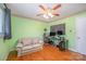 Bedroom featuring hardwood floors, a ceiling fan, a small couch and recording equipment at 1206 Mineral Springs Rd, Charlotte, NC 28262