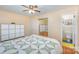 Bedroom featuring wood floors, a ceiling fan, a sliding mirror closet and an ensuite bathroom at 1206 Mineral Springs Rd, Charlotte, NC 28262