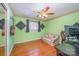 This bedroom features hardwood floors, a small couch and access to a sliding mirror closet at 1206 Mineral Springs Rd, Charlotte, NC 28262