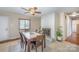 Dining room with brick fireplace, ceiling fan, and table for six at 1206 Mineral Springs Rd, Charlotte, NC 28262