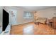 Open living room with wood floors, a large window, and neutral paint colors at 1206 Mineral Springs Rd, Charlotte, NC 28262