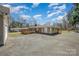 The rear of the home includes a back deck and long, paved driveway at 1206 Mineral Springs Rd, Charlotte, NC 28262