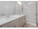 Modern bathroom with double vanity, herringbone tile, and glass enclosed shower at 4861 Blanchard Way, Charlotte, NC 28226