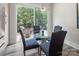 Cozy breakfast nook with glass table, backyard view, and lots of natural light at 4861 Blanchard Way, Charlotte, NC 28226