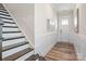 Bright foyer features wood-look floors, paneled wainscoting and staircase to the upper level at 4861 Blanchard Way, Charlotte, NC 28226