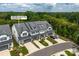 Exterior elevation showcasing three-story townhomes featuring multiple garages with private driveways at 4861 Blanchard Way, Charlotte, NC 28226