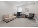 A well-lit home office with plush seating, desk, and ample workspace at 4861 Blanchard Way, Charlotte, NC 28226