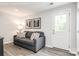 Basement room with gray couch and white door leading to backyard at 5235 Stevedore Way, Charlotte, NC 28269