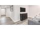 Finished basement with gray sofa, dark wood cabinet, and hardwood floors at 5235 Stevedore Way, Charlotte, NC 28269