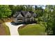 Aerial view of a charming two-story house with a lush green lawn and a two-car garage at 6178 Chimney Bluff Rd, Lancaster, SC 29720