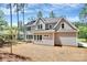 A spacious backyard and the rear exterior of a two-story home featuring large windows, and gray siding at 6178 Chimney Bluff Rd, Lancaster, SC 29720