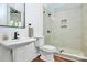 Modern bathroom featuring a glass walk-in shower, a pedestal sink, and updated fixtures at 6178 Chimney Bluff Rd, Lancaster, SC 29720