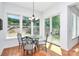 Bright dining area with a chandelier and views of the wooded backyard at 6178 Chimney Bluff Rd, Lancaster, SC 29720