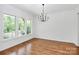 Elegant dining room with hardwood floors, chandelier, and large windows at 6178 Chimney Bluff Rd, Lancaster, SC 29720