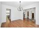 Open dining area with hardwood floors, chandelier, and seamless flow to other living spaces at 6178 Chimney Bluff Rd, Lancaster, SC 29720