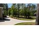 Long concrete driveway leading to a home surrounded by lush greenery and mature trees, offering privacy at 6178 Chimney Bluff Rd, Lancaster, SC 29720