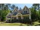 Charming two-story home with a covered front porch, a lawn and mature landscaping at 6178 Chimney Bluff Rd, Lancaster, SC 29720