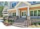 Inviting front porch with stone accents, brick steps, and a stylish wood ceiling at 6178 Chimney Bluff Rd, Lancaster, SC 29720