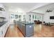 Open concept kitchen featuring white cabinets, granite counters, stainless steel appliances, and eat-in nook at 6178 Chimney Bluff Rd, Lancaster, SC 29720