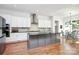 Modern eat-in kitchen featuring white cabinets, a gray island, granite counters, and stainless steel appliances at 6178 Chimney Bluff Rd, Lancaster, SC 29720