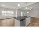 Modern kitchen island with granite countertops and stainless steel appliances at 5051 Oxbow Run Ln, Clover, SC 29710