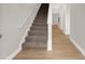 Modern staircase with carpeted steps and wood flooring at 5051 Oxbow Run Ln, Clover, SC 29710