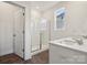 Bright bathroom with double vanity, shower, and tile floors at 730 Olde England Dr, Lincolnton, NC 28092