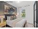 Bright bedroom with a queen-size bed and natural light at 8104 Haidas Ave # 036, Charlotte, NC 28214