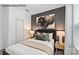 Cozy bedroom with a queen-size bed and large artwork at 8104 Haidas Ave # 036, Charlotte, NC 28214