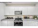 White kitchen cabinets and granite countertops at 8104 Haidas Ave # 036, Charlotte, NC 28214