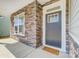 Inviting front porch features stone accents, a modern door, and a welcoming entrance at 8708 Frank Grier Rd # 53, Charlotte, NC 28215